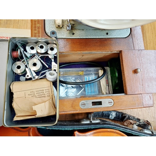 366 - A cased Frister & Rossmann electric sewing machine with foot pedal, attachments, accessories and ins... 