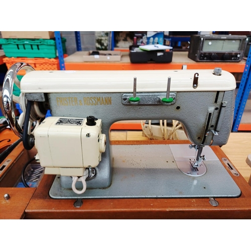366 - A cased Frister & Rossmann electric sewing machine with foot pedal, attachments, accessories and ins... 