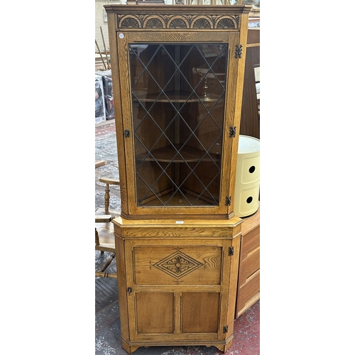 21 - A Jaycee carved oak and lead glazed corner display cabinet - approx. 171cm high x 67cm wide x 40cm d... 