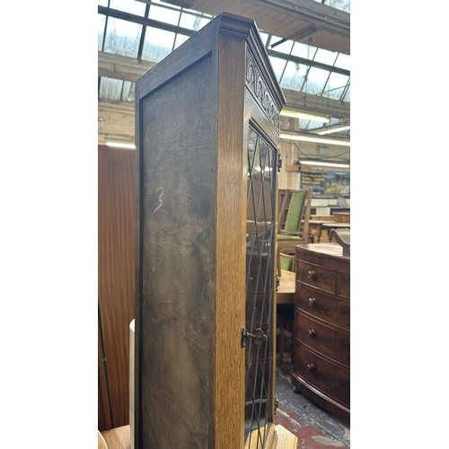 21 - A Jaycee carved oak and lead glazed corner display cabinet - approx. 171cm high x 67cm wide x 40cm d... 