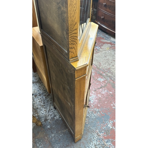21 - A Jaycee carved oak and lead glazed corner display cabinet - approx. 171cm high x 67cm wide x 40cm d... 