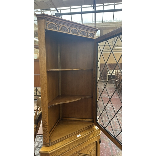 21 - A Jaycee carved oak and lead glazed corner display cabinet - approx. 171cm high x 67cm wide x 40cm d... 