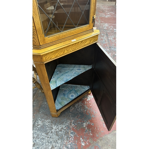 21 - A Jaycee carved oak and lead glazed corner display cabinet - approx. 171cm high x 67cm wide x 40cm d... 