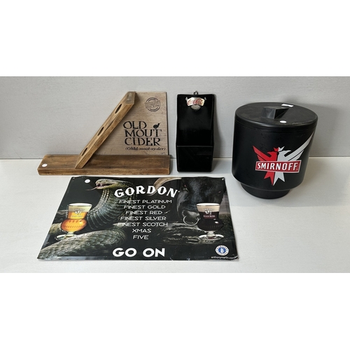 61 - Four advertising items, one Coca-Cola black plastic and metal bottle opener, one Smirnoff black plas... 