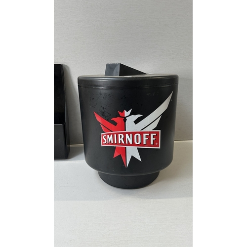 61 - Four advertising items, one Coca-Cola black plastic and metal bottle opener, one Smirnoff black plas... 