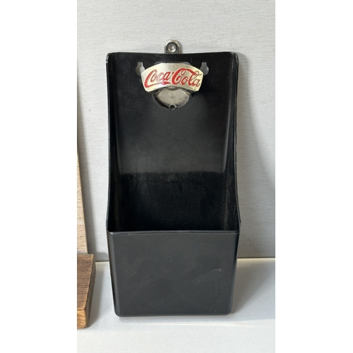 61 - Four advertising items, one Coca-Cola black plastic and metal bottle opener, one Smirnoff black plas... 