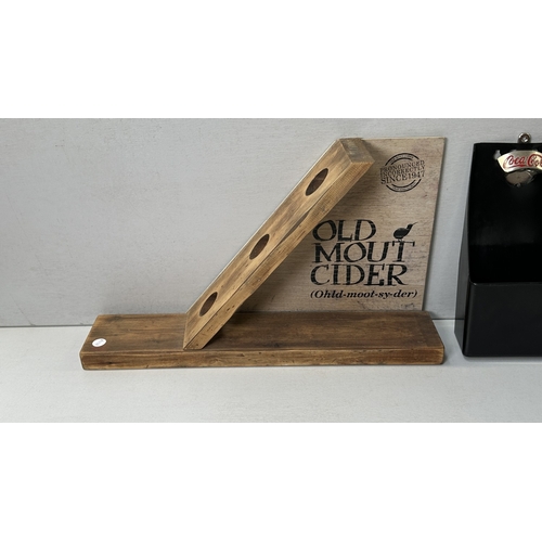 61 - Four advertising items, one Coca-Cola black plastic and metal bottle opener, one Smirnoff black plas... 