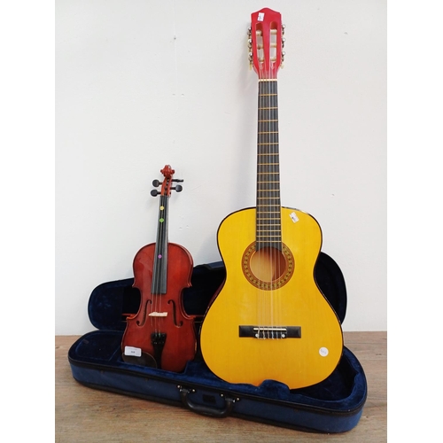 368 - Two child's ½ size musical instruments, one cased Mayflower violin with bow and one nylon strung cla... 