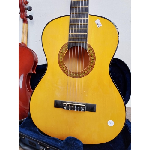 368 - Two child's ½ size musical instruments, one cased Mayflower violin with bow and one nylon strung cla... 