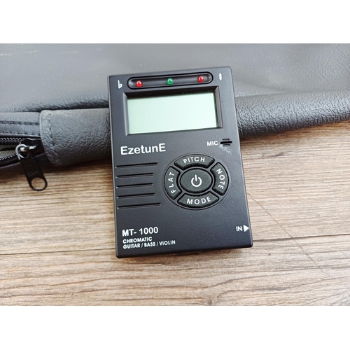 369 - A cased Encore short-scale electric bass guitar with EzetunE MT-1000 electronic chromatic tuner and ... 