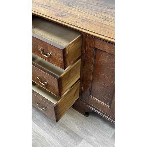 108 - A Georgian oak dresser base - approx. 82cm high x 207cm wide x 52cm deep