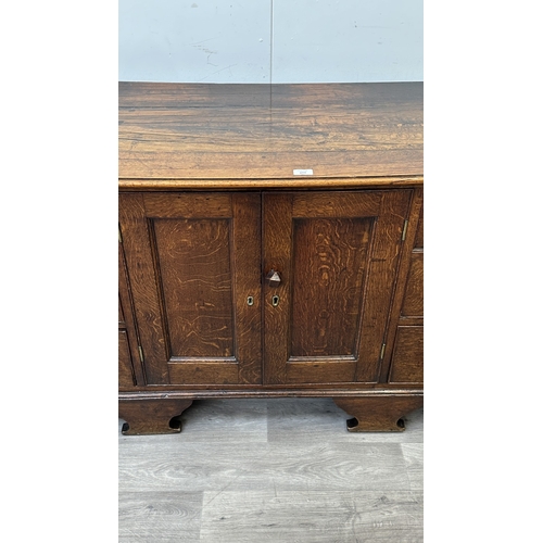 108 - A Georgian oak dresser base - approx. 82cm high x 207cm wide x 52cm deep