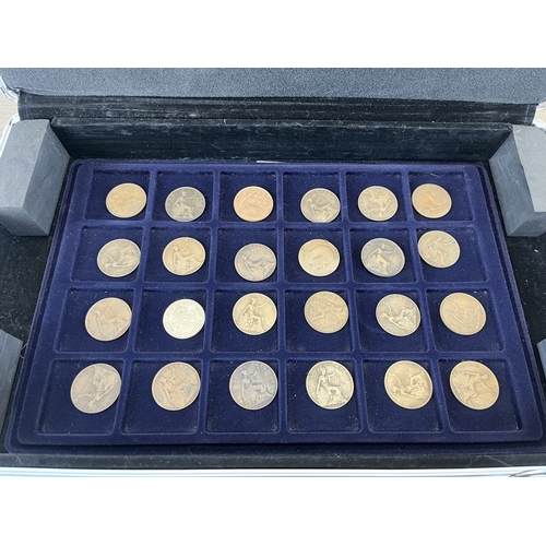 Two aluminium coin cases containing a collection of world coins