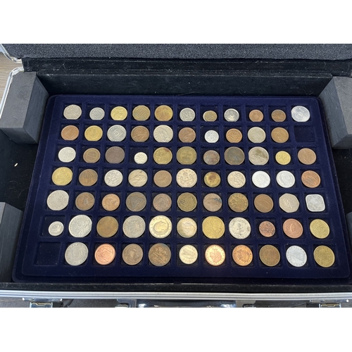 Two aluminium coin cases containing a collection of world coins
