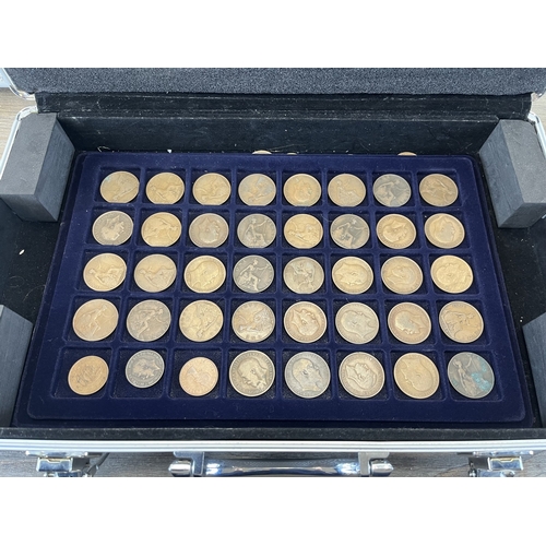Two aluminium coin cases containing a collection of world coins