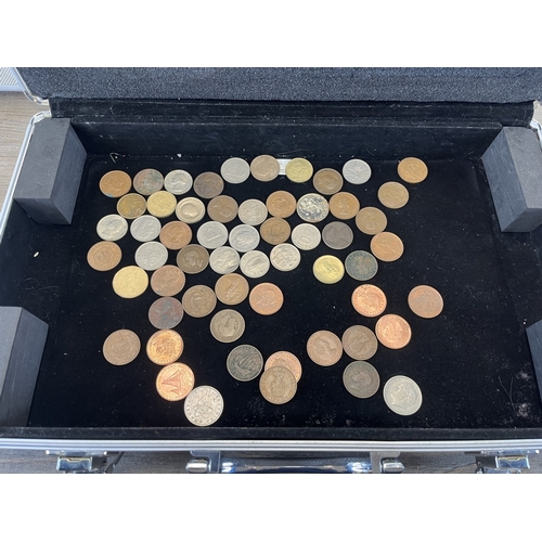 Two aluminium coin cases containing a collection of world coins