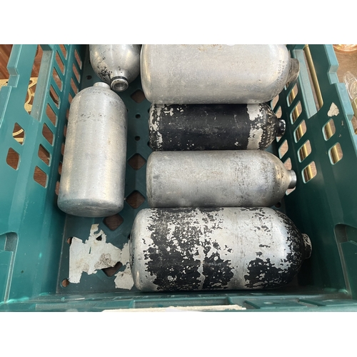 252 - Nine metal gas cylinders - approx. 21cm high