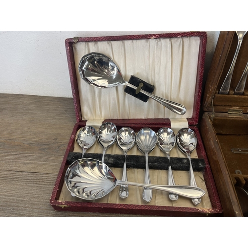 260 - Four boxes containing metalware, three containing cutlery and one containing pewter ware to include ... 
