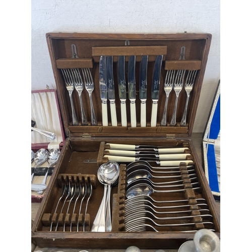 260 - Four boxes containing metalware, three containing cutlery and one containing pewter ware to include ... 