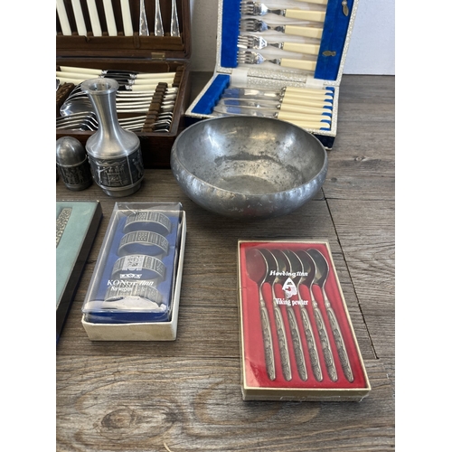 260 - Four boxes containing metalware, three containing cutlery and one containing pewter ware to include ... 