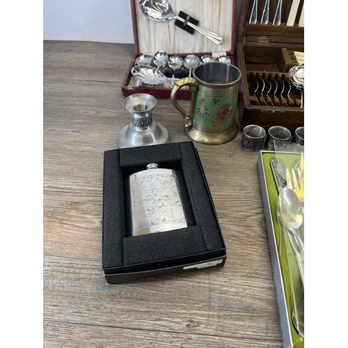 260 - Four boxes containing metalware, three containing cutlery and one containing pewter ware to include ... 