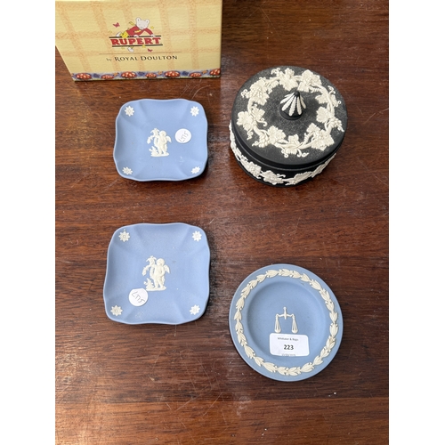 223 - Six pieces of ceramics, two boxed Royal Doulton Rupert figurines; Rupert's Silver Trumpet and Rupert... 