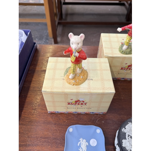223 - Six pieces of ceramics, two boxed Royal Doulton Rupert figurines; Rupert's Silver Trumpet and Rupert... 