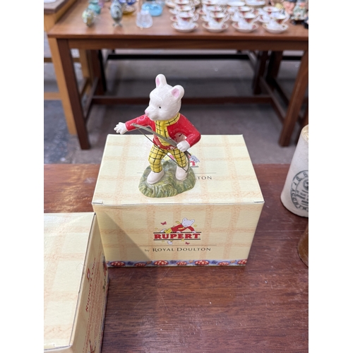 223 - Six pieces of ceramics, two boxed Royal Doulton Rupert figurines; Rupert's Silver Trumpet and Rupert... 