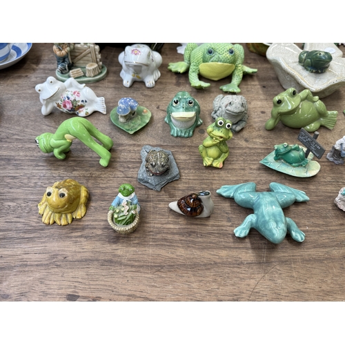 242 - Approx. thirty nine various frog figurines to include ceramic, resin etc. together with a ceramic sn... 