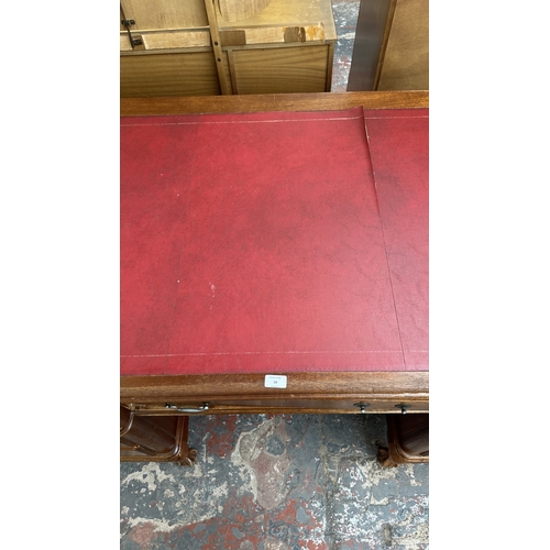 10 - A 19th century style mahogany pedestal writing desk with red leather top and ball and claw supports ... 