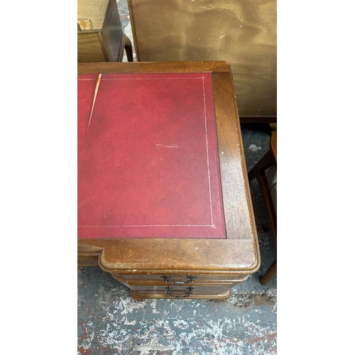 10 - A 19th century style mahogany pedestal writing desk with red leather top and ball and claw supports ... 