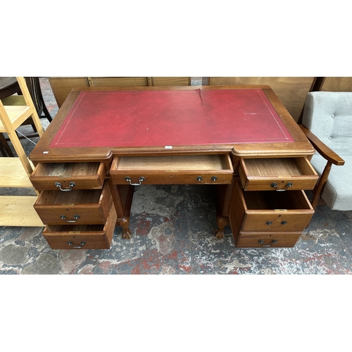 10 - A 19th century style mahogany pedestal writing desk with red leather top and ball and claw supports ... 