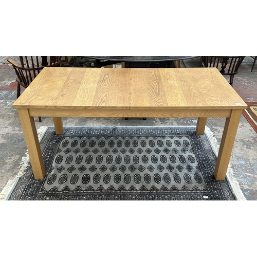 100 - A 1990s Habitat oak extending dining table designed by Terence Conran, made in Denmark - approx. 74c... 