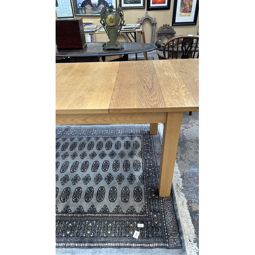 100 - A 1990s Habitat oak extending dining table designed by Terence Conran, made in Denmark - approx. 74c... 