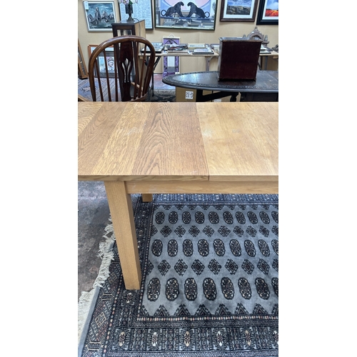 100 - A 1990s Habitat oak extending dining table designed by Terence Conran, made in Denmark - approx. 74c... 