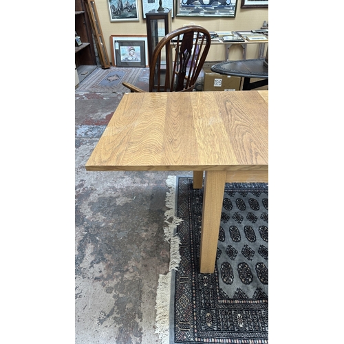 100 - A 1990s Habitat oak extending dining table designed by Terence Conran, made in Denmark - approx. 74c... 