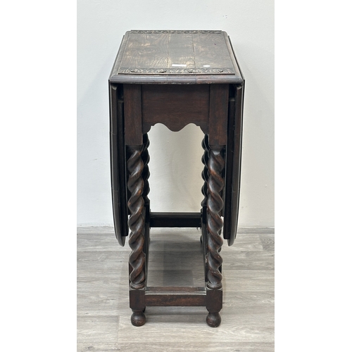 105 - An early 20th century carved oak oval drop leaf gate leg barley twist occasional table - approx. 77c... 