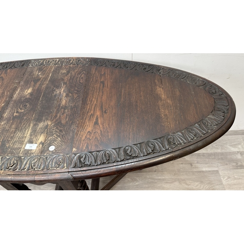 105 - An early 20th century carved oak oval drop leaf gate leg barley twist occasional table - approx. 77c... 
