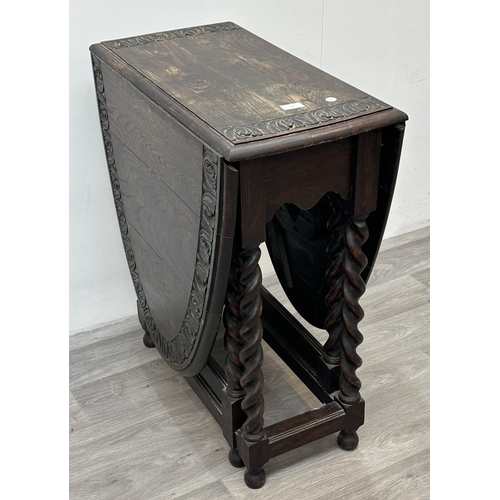 105 - An early 20th century carved oak oval drop leaf gate leg barley twist occasional table - approx. 77c... 