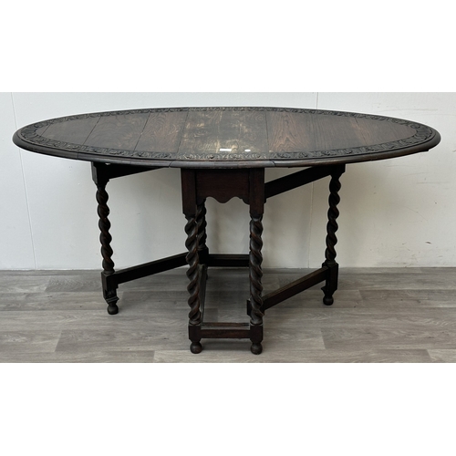 105 - An early 20th century carved oak oval drop leaf gate leg barley twist occasional table - approx. 77c... 