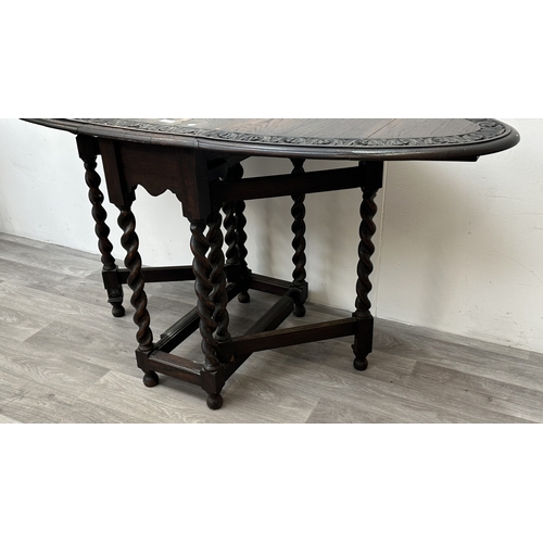 105 - An early 20th century carved oak oval drop leaf gate leg barley twist occasional table - approx. 77c... 