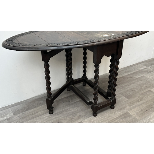 105 - An early 20th century carved oak oval drop leaf gate leg barley twist occasional table - approx. 77c... 