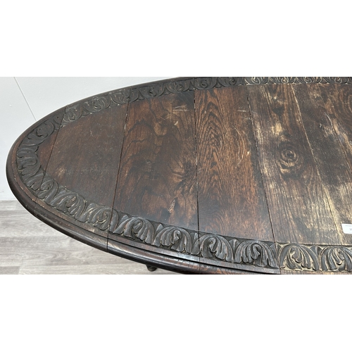 105 - An early 20th century carved oak oval drop leaf gate leg barley twist occasional table - approx. 77c... 