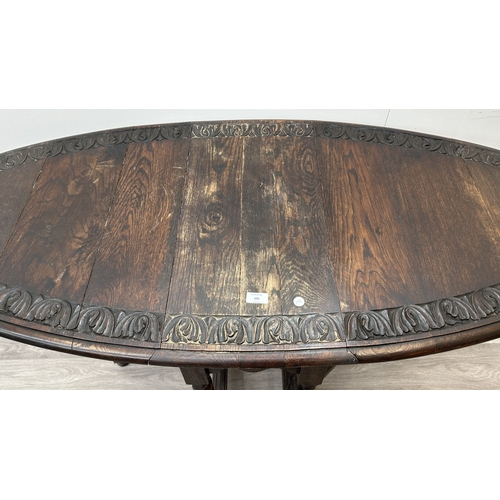 105 - An early 20th century carved oak oval drop leaf gate leg barley twist occasional table - approx. 77c... 
