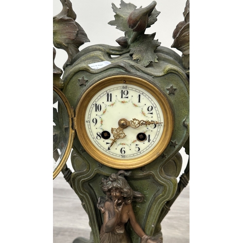 107 - An Art Nouveau French cast metal figural mantel clock with hand painted enamel face and foliate deco... 
