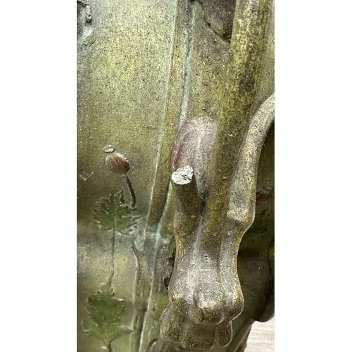 107 - An Art Nouveau French cast metal figural mantel clock with hand painted enamel face and foliate deco... 