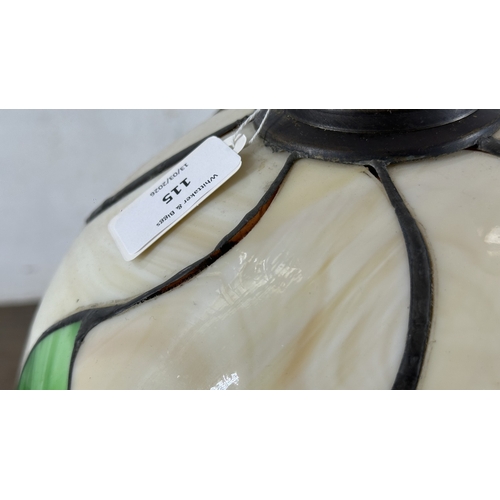 115 - A Tiffany style stained glass and bronzed cast metal table lamp - approx. 37cm high