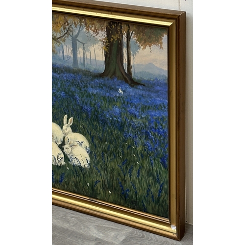 116A - A late 20th century gilt framed oil on canvas titled 'Alice in Wonderland, Feeding the Rabbits' afte... 