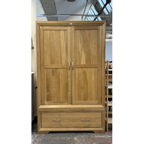 12 - A modern oak double wardrobe - approx. 194cm high x 118cm wide x 60cm deep