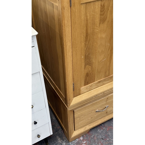 12 - A modern oak double wardrobe - approx. 194cm high x 118cm wide x 60cm deep